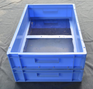 A screen mealworm breeding system, comprising of two blue mealworms trays on top of each other. The top one has a screen on the bottom.The bottom one has a solid base to collect baby mealworms.