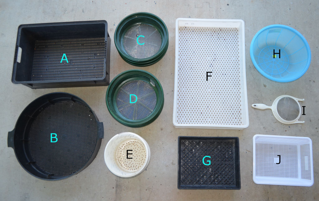 Photo of ten different sieve options for cleaning, filtering and harvesting mealworms. Photo includes: A) square worm farm B) Round worm farm C) and D) Gold sieves, E) Container with holes drilled in it F) Perforated plastic tray G) Nursery tray H) and I) Household noodle strainers J) Plastic perforated container